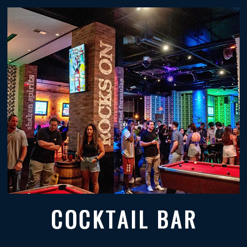 Cocktail bar with vibrant lighting, pool tables and people socializing near brick columns