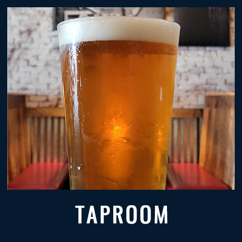 Close-up of a pint of beer in a cozy taproom with wooden booths and red seating