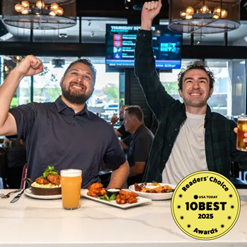 Two men cheer with food & drinks at a sports bar; USA Today 10 Best Readers' Choice 2025 Awards l
